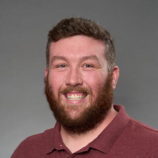 A headshot of Residence Hall Desk Coordinator Kevin Scott