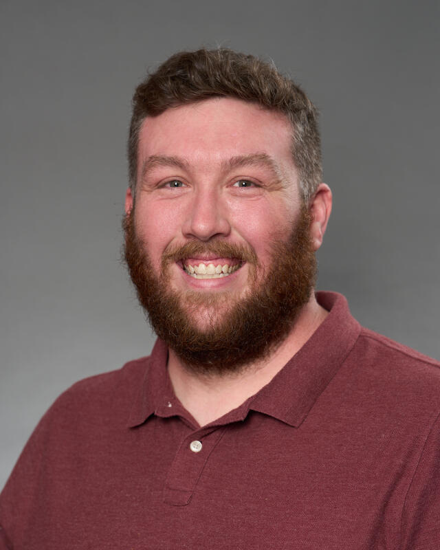 A headshot of Residence Hall Desk Coordinator Kevin Scott